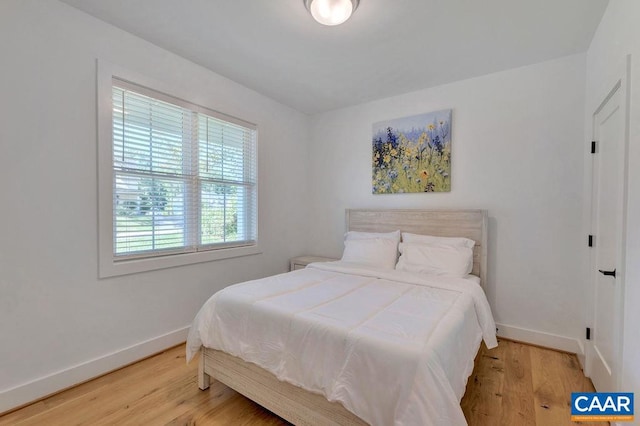 bedroom featuring baseboards and wood finished floors