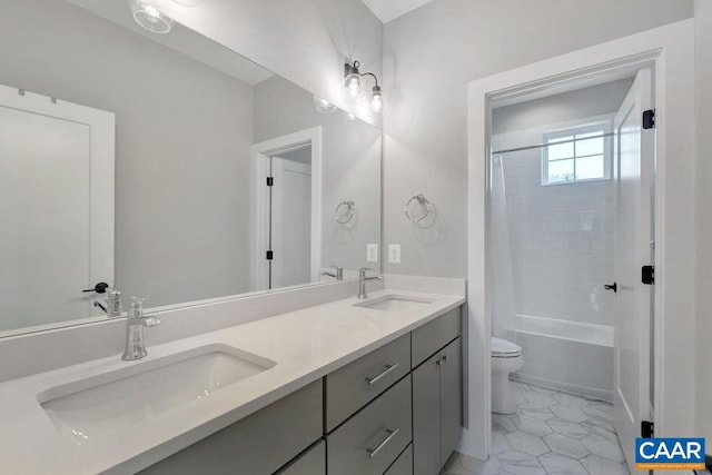 bathroom with double vanity, toilet, shower / tub combo, and a sink