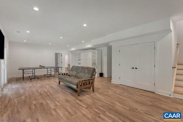 living room featuring recessed lighting, stairway, and light wood-style flooring