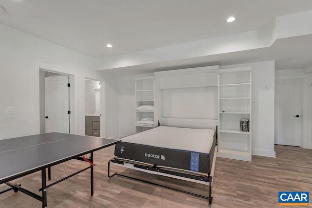 bedroom with recessed lighting, baseboards, and wood finished floors