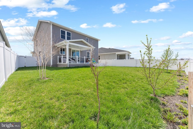 back of property featuring a lawn and a fenced backyard