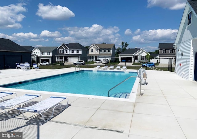 pool with fence, a residential view, and a patio