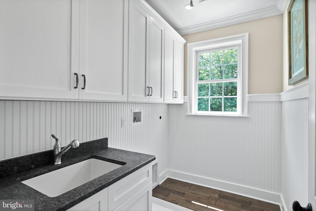 washroom featuring a sink, washer hookup, cabinet space, electric dryer hookup, and dark wood-style flooring