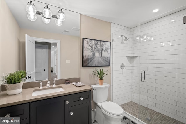 full bath with visible vents, toilet, a stall shower, and vanity