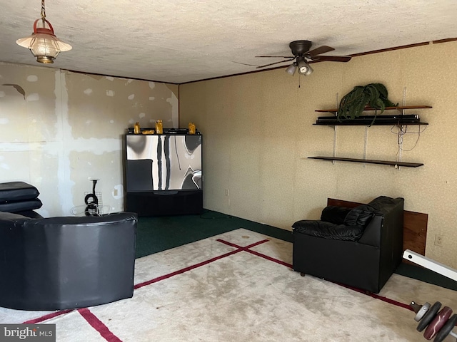 living area featuring a textured ceiling and a ceiling fan