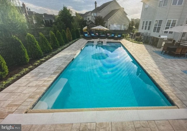 view of pool with a fenced in pool and a patio