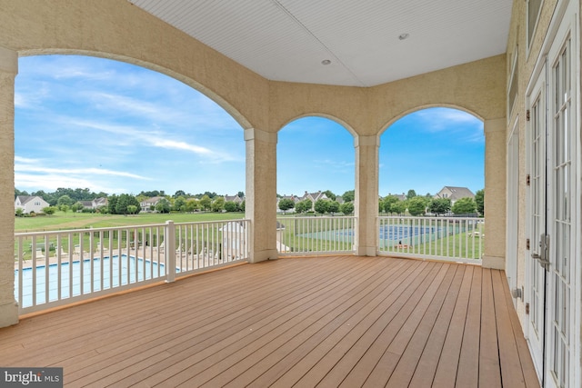 wooden deck with a fenced in pool