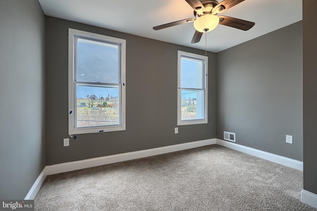 unfurnished room with visible vents, carpet flooring, and baseboards