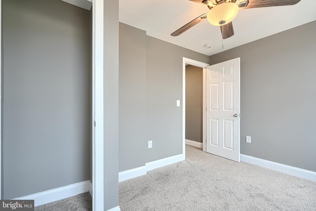 unfurnished bedroom featuring carpet flooring, baseboards, and ceiling fan