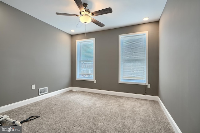 spare room featuring carpet, baseboards, visible vents, recessed lighting, and ceiling fan