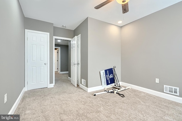 unfurnished room featuring visible vents, carpet flooring, baseboards, and a ceiling fan