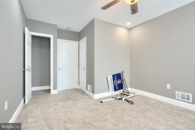 workout room featuring visible vents, baseboards, ceiling fan, and carpet flooring