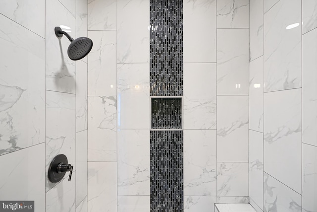 interior details with a tile shower