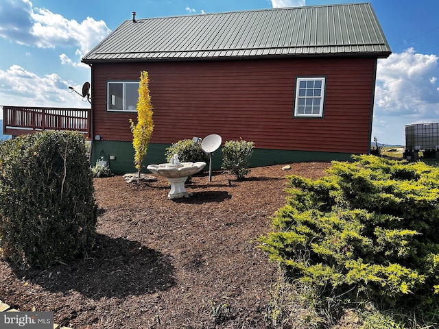 view of property exterior with crawl space and metal roof