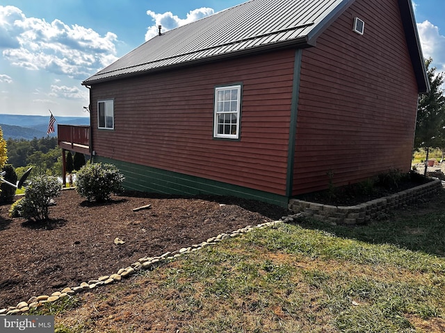 view of property exterior with metal roof and a standing seam roof