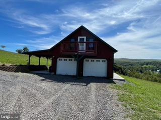 garage featuring a carport and driveway