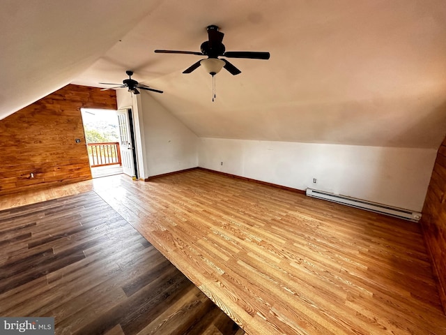 bonus room with a ceiling fan, wood finished floors, baseboards, a baseboard radiator, and vaulted ceiling