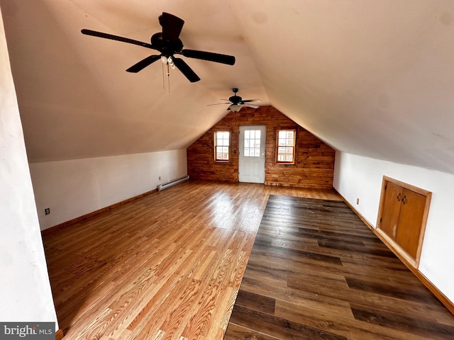 bonus room featuring a ceiling fan, wood finished floors, baseboards, a baseboard radiator, and lofted ceiling