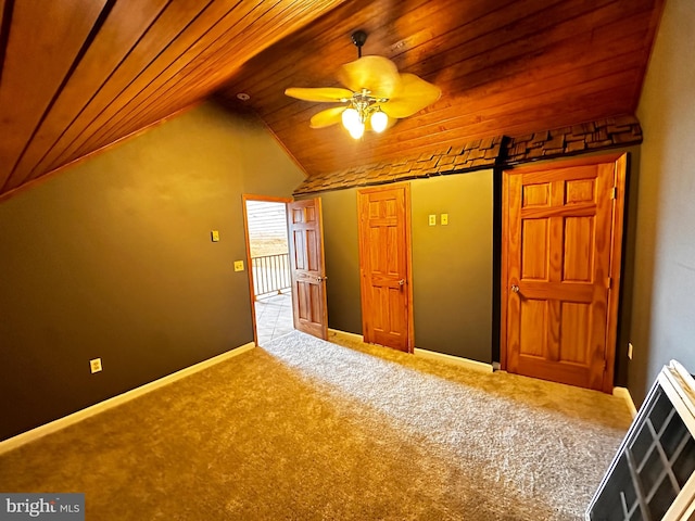 additional living space featuring carpet, baseboards, wood ceiling, ceiling fan, and vaulted ceiling