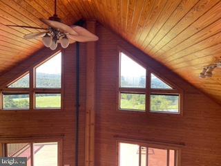 bonus room featuring wooden ceiling, lofted ceiling, and a ceiling fan