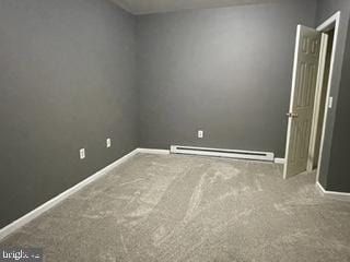 carpeted empty room with baseboards and a baseboard radiator