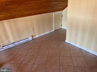 bonus room with tile patterned floors, a baseboard radiator, baseboards, wood ceiling, and vaulted ceiling