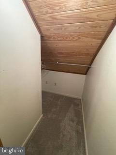 hallway with baseboards, wood ceiling, lofted ceiling, and carpet floors