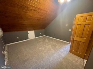 additional living space with wooden ceiling, baseboards, carpet, and vaulted ceiling