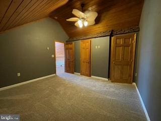 additional living space with baseboards, lofted ceiling, carpet floors, and wooden ceiling