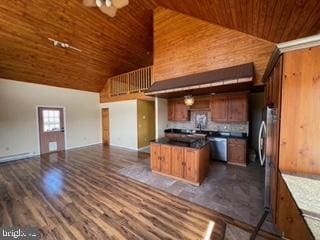 kitchen featuring wooden ceiling, dark countertops, open floor plan, and high vaulted ceiling