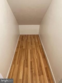 interior space with baseboards and wood finished floors