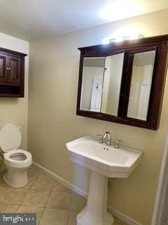 bathroom featuring tile patterned floors, toilet, and baseboards