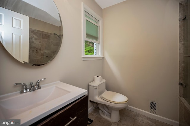 2036 Coast Guard Dr, Stafford, VA 22554 - bathroom featuring baseboards, vanity, toilet, tiled shower, and tile patterned floors