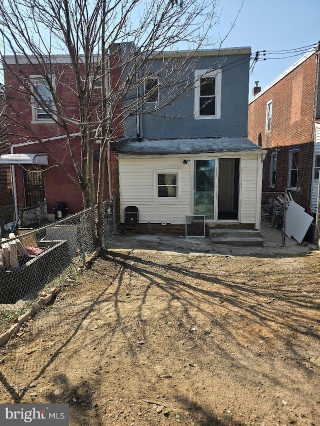 back of house with entry steps and fence