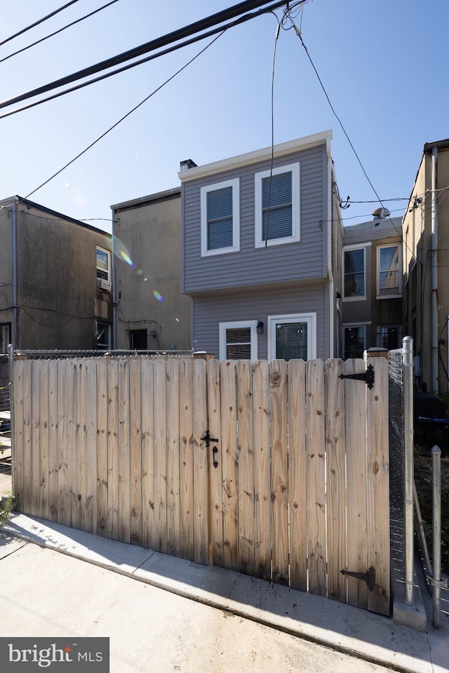 view of front of house with a fenced front yard and a gate