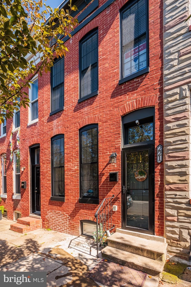 view of front of house featuring entry steps and brick siding