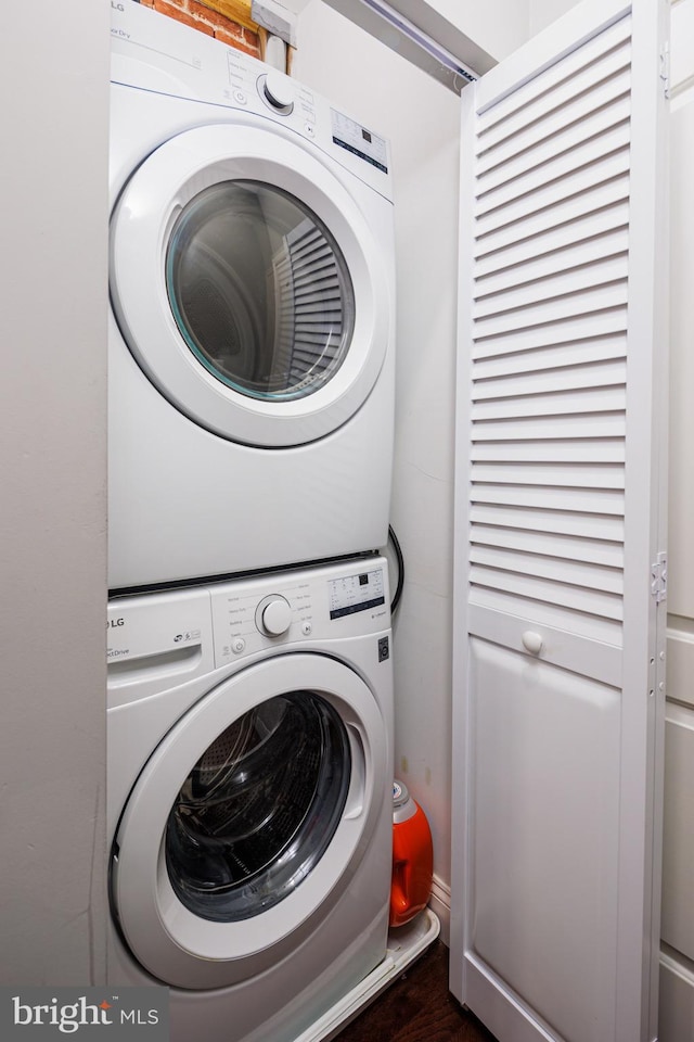 laundry area featuring laundry area and stacked washer / dryer