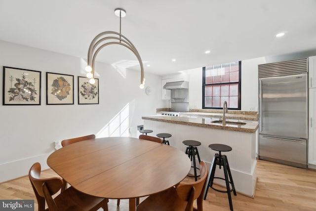 dining space featuring recessed lighting and light wood-type flooring