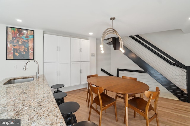 dining area with recessed lighting and light wood-style flooring