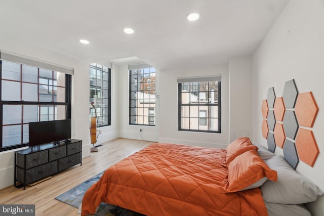 bedroom with recessed lighting, baseboards, and wood finished floors