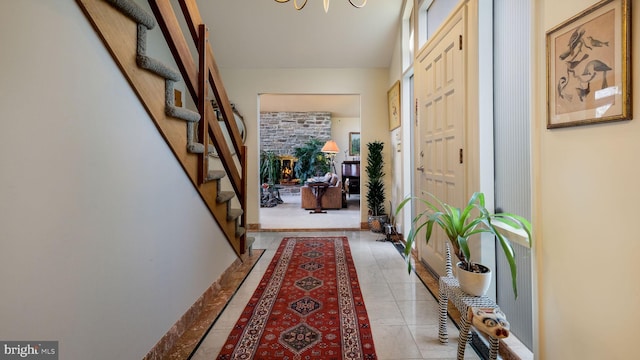 foyer entrance featuring stairway and light tile patterned floors