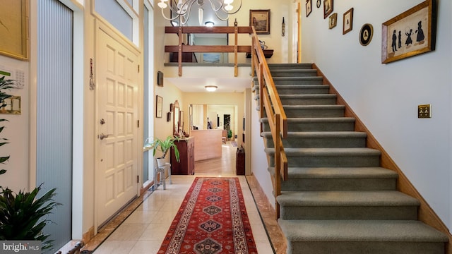 entrance foyer with stairs, light tile patterned floors, and a chandelier