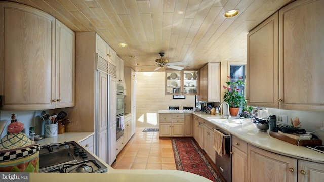 kitchen with light brown cabinets, a sink, stainless steel appliances, wooden ceiling, and light tile patterned flooring