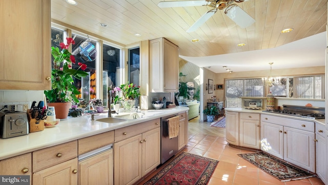 kitchen featuring light tile patterned floors, stainless steel appliances, light countertops, and a ceiling fan