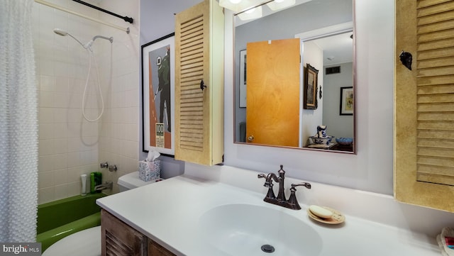 bathroom featuring visible vents, vanity, toilet, and shower / bath combo with shower curtain