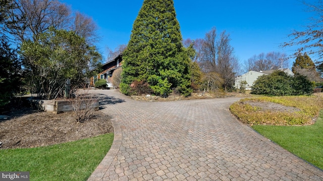 exterior space featuring decorative driveway