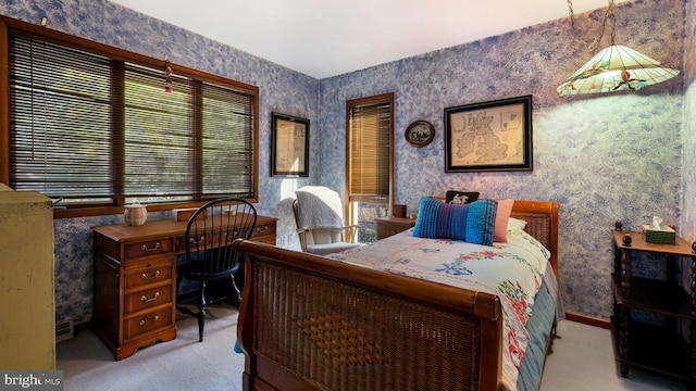 bedroom with wallpapered walls, baseboards, and light carpet