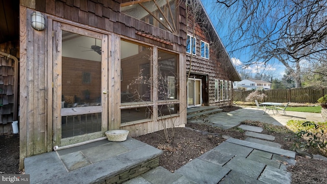 view of side of property with fence and a patio area