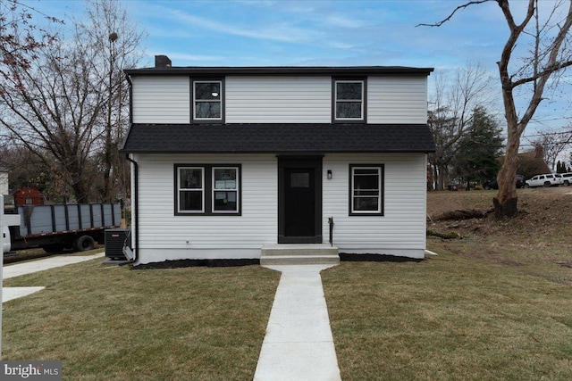 view of front of house with a chimney, central air condition unit, a front lawn, and roof with shingles