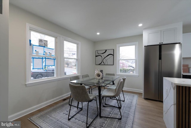 dining area with recessed lighting, baseboards, and light wood-type flooring